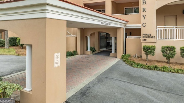 property entrance featuring stucco siding and a tiled roof