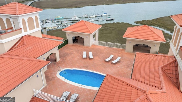 view of swimming pool with a gazebo, a water view, and a patio