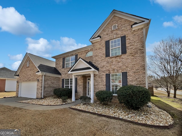 traditional-style house featuring concrete driveway, brick siding, and an attached garage