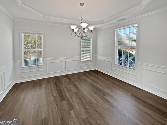 unfurnished dining area featuring a healthy amount of sunlight, a chandelier, a raised ceiling, and dark wood-style flooring