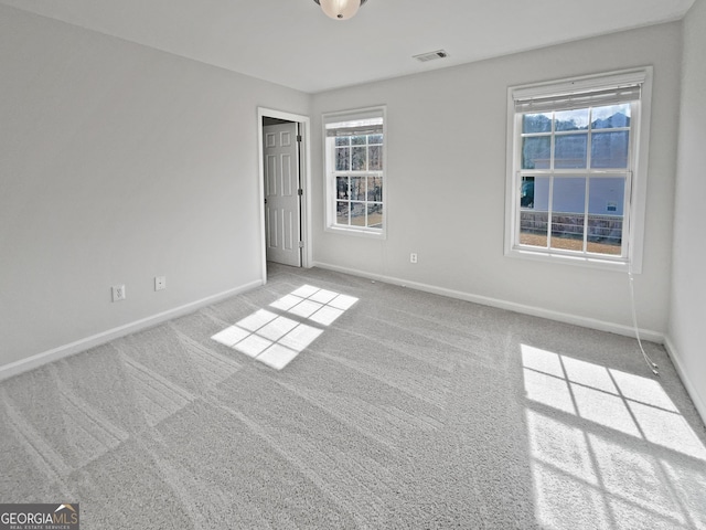 unfurnished bedroom featuring carpet flooring, visible vents, and baseboards