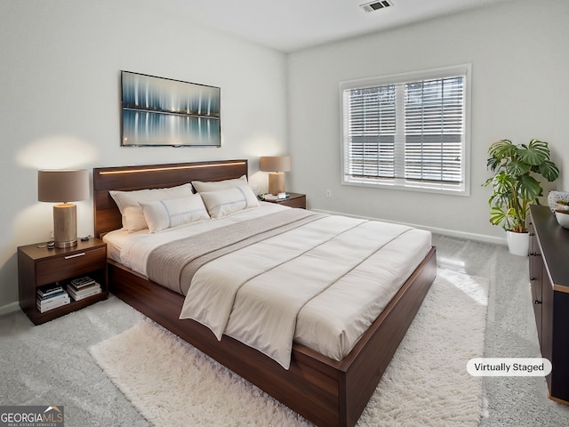 carpeted bedroom featuring visible vents and baseboards