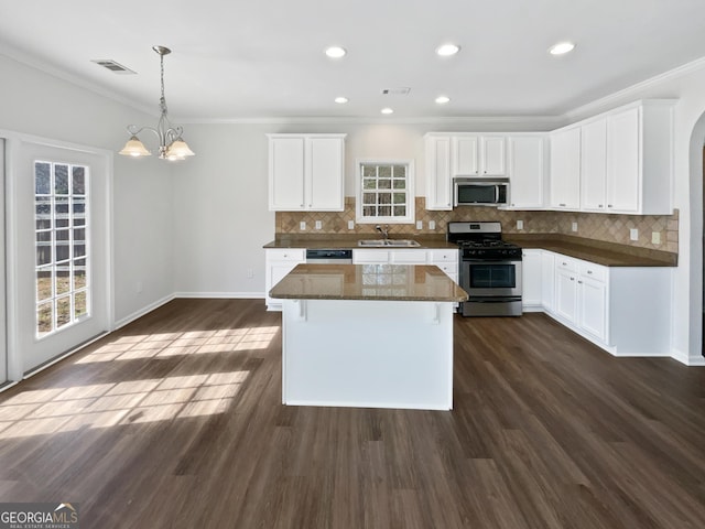 kitchen featuring dark wood-style floors, visible vents, and stainless steel appliances