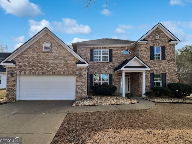 traditional-style home featuring concrete driveway, brick siding, and an attached garage