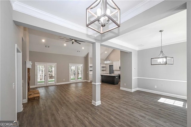 unfurnished living room featuring dark wood-style flooring, french doors, ornamental molding, vaulted ceiling, and baseboards