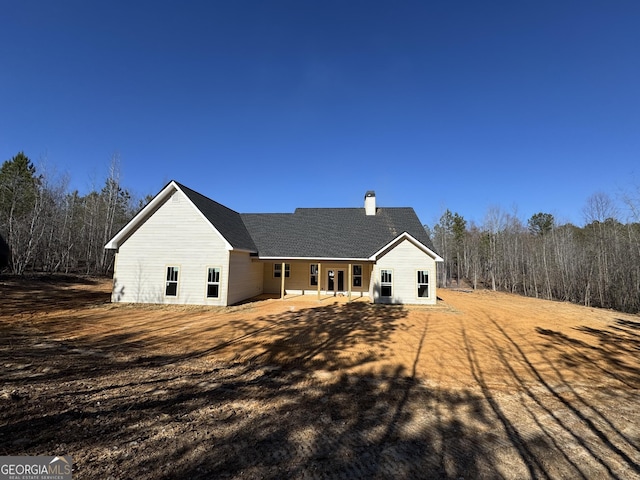 back of property with a patio area and a chimney