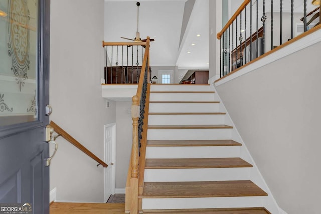 staircase with recessed lighting and baseboards