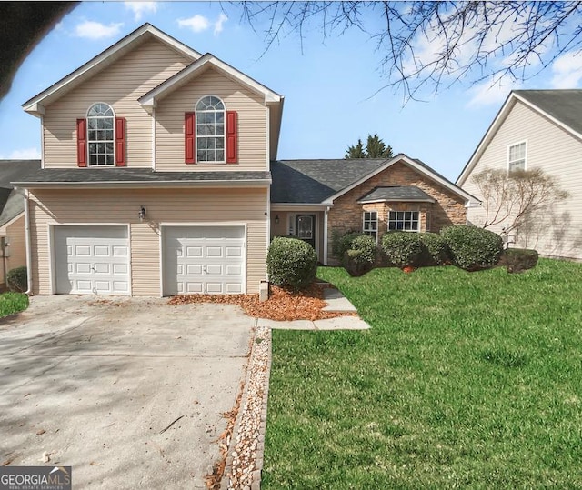 view of front facade with a garage, driveway, and a front yard