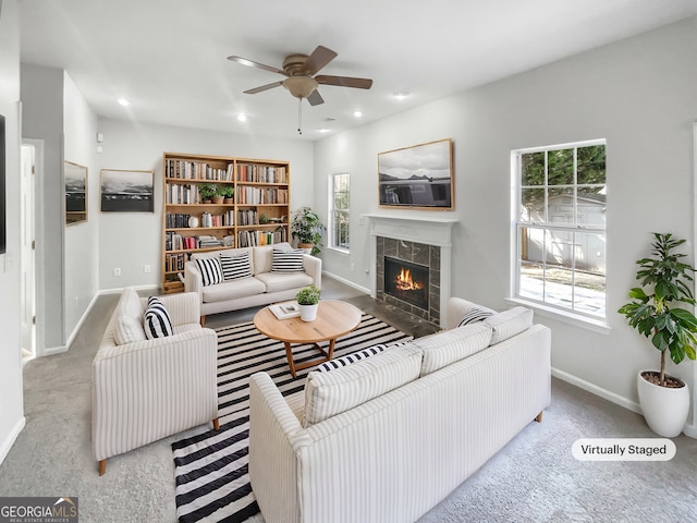 carpeted living area featuring recessed lighting, baseboards, ceiling fan, and a tiled fireplace