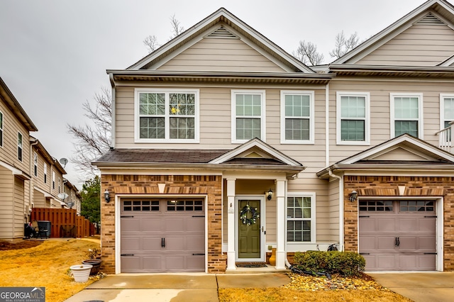 view of front of property with a garage, concrete driveway, and brick siding