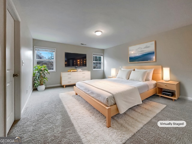 bedroom featuring carpet flooring, visible vents, and baseboards