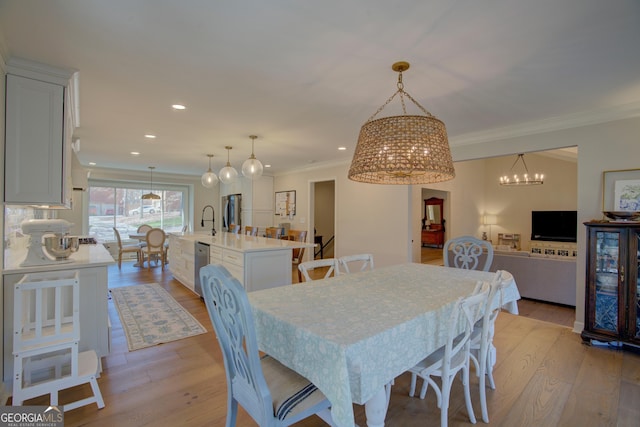 dining room featuring recessed lighting, crown molding, and light wood finished floors