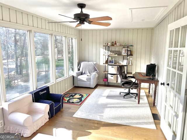 office featuring a ceiling fan, visible vents, and wood finished floors