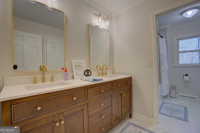 bathroom with double vanity, visible vents, a sink, and ornamental molding