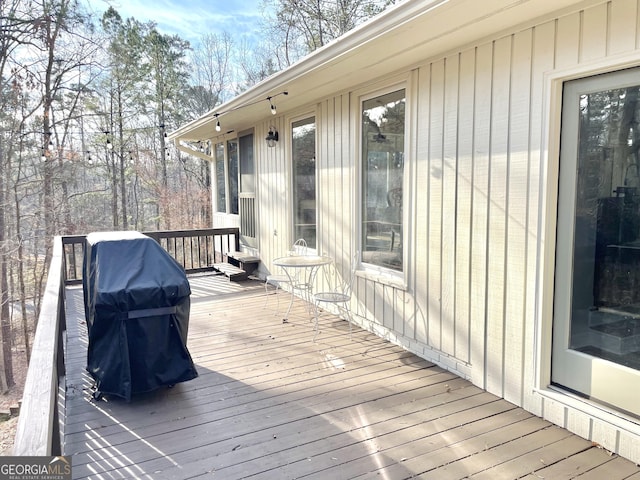 wooden terrace with a grill