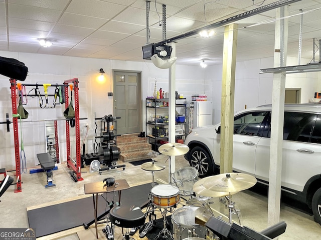 garage with freestanding refrigerator and a garage door opener