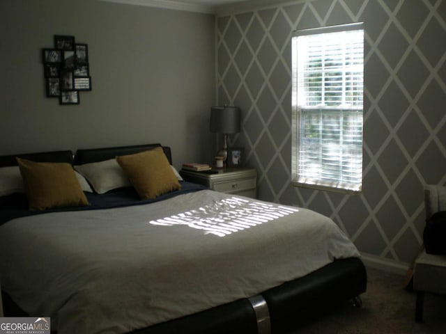 bedroom with an accent wall and ornamental molding