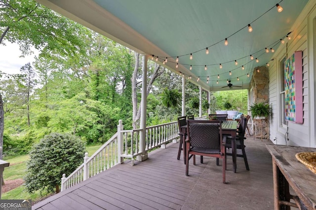 wooden deck with ceiling fan and outdoor dining area