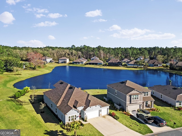 birds eye view of property featuring a water view and a residential view