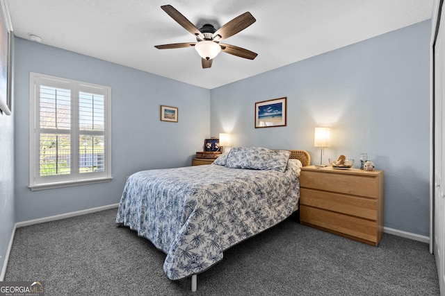 bedroom with a ceiling fan, carpet flooring, and baseboards