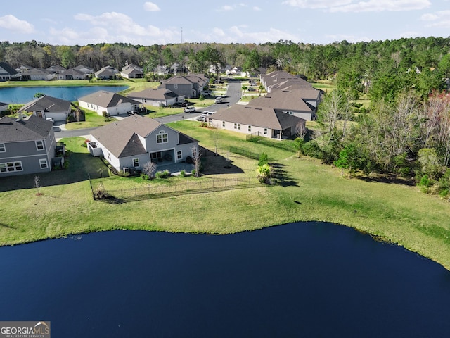 drone / aerial view with a water view and a residential view