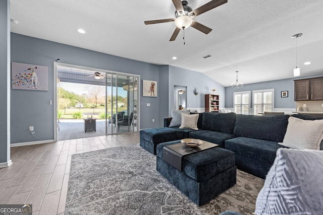 living room featuring vaulted ceiling, wood finish floors, a textured ceiling, and recessed lighting