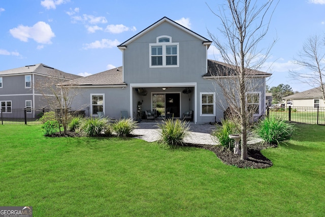 rear view of property featuring stucco siding, a fenced backyard, a lawn, and a patio