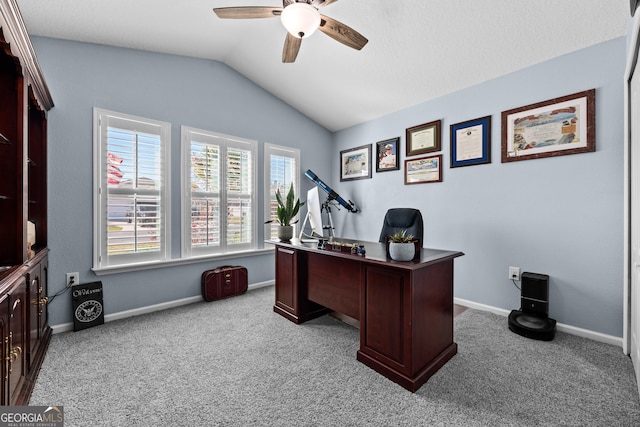 office featuring lofted ceiling, light carpet, ceiling fan, and baseboards