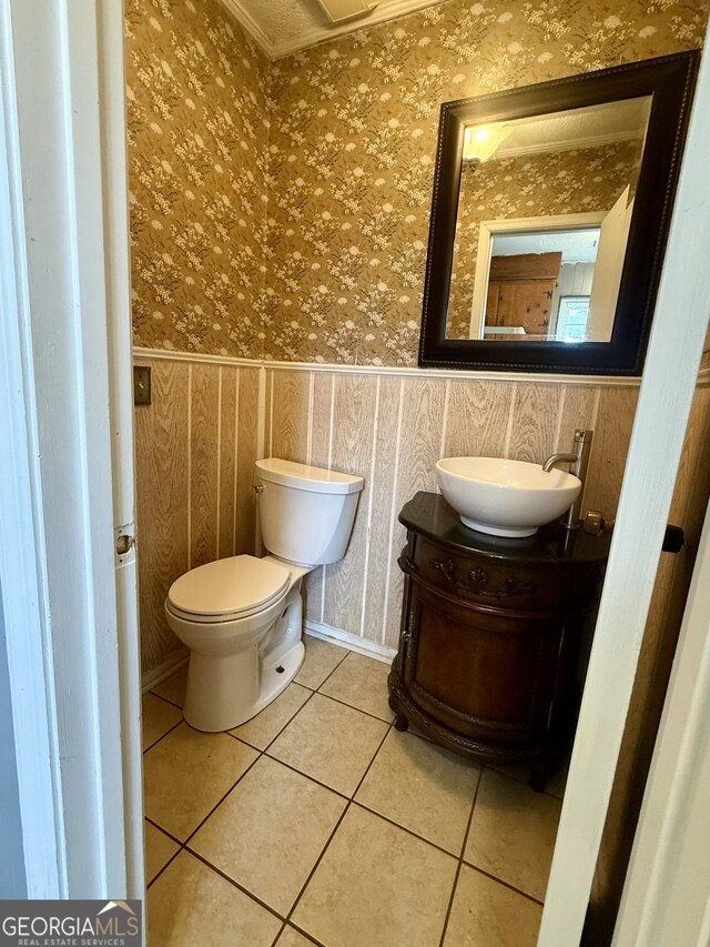 312 Schuman Dr, Bloomingdale, GA 31302 - bathroom featuring wallpapered walls, tile patterned floors, vanity, toilet, and ornamental molding