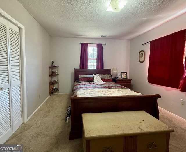 312 Schuman Dr, Bloomingdale, GA 31302 - carpeted bedroom featuring a textured ceiling and baseboards