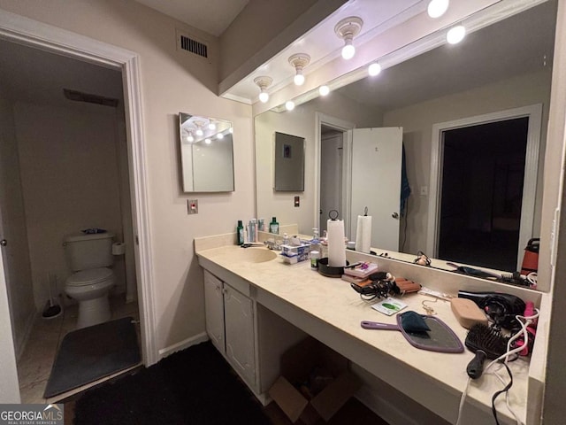 bathroom with visible vents, baseboards, vanity, and toilet