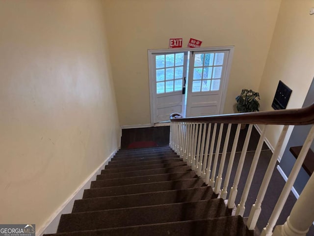 stairs with baseboards and wood finished floors