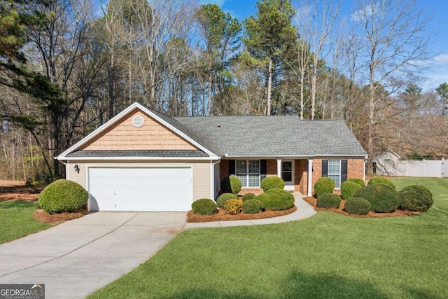 ranch-style house featuring brick siding, a shingled roof, an attached garage, a front yard, and driveway