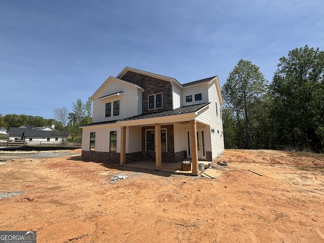 790 Ferguson Pl, Dallas, GA 30132 - modern farmhouse style home featuring board and batten siding, a standing seam roof, stone siding, and metal roof