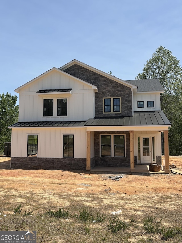790 Ferguson Pl, Dallas, GA 30132 - modern farmhouse style home featuring board and batten siding, a porch, a standing seam roof, and metal roof