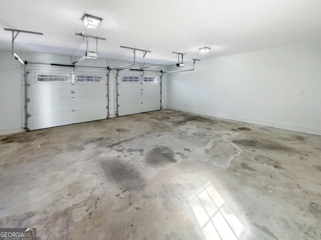 garage with a garage door opener and baseboards