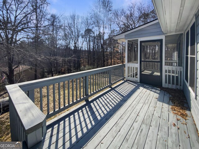 wooden terrace featuring a sunroom