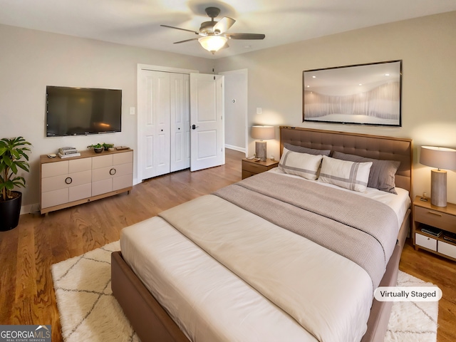 bedroom with a closet, ceiling fan, baseboards, and wood finished floors