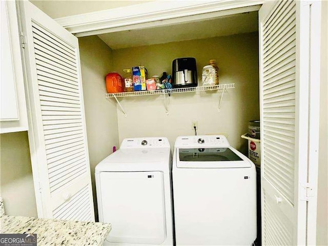 washroom featuring laundry area and separate washer and dryer