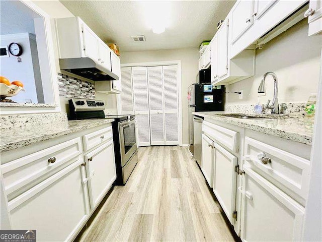 kitchen featuring light stone counters, stainless steel appliances, under cabinet range hood, white cabinetry, and a sink