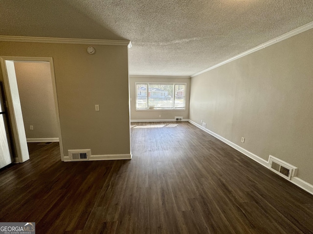 unfurnished living room featuring visible vents, dark wood-type flooring, and ornamental molding