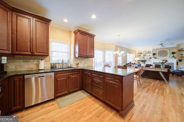 kitchen with dishwasher, a peninsula, light wood-type flooring, and a sink