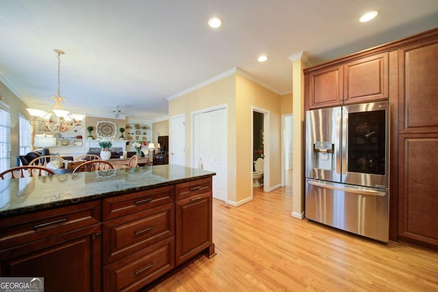 kitchen featuring crown molding, a notable chandelier, stainless steel refrigerator with ice dispenser, light wood-style flooring, and dark stone counters