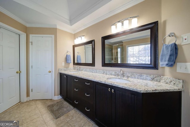 full bathroom with double vanity, crown molding, a sink, and tile patterned floors