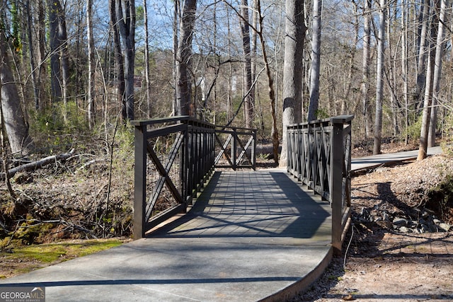 view of gate with a wooded view