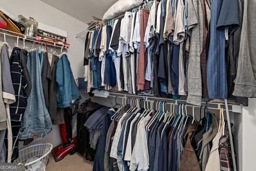 walk in closet with carpet floors