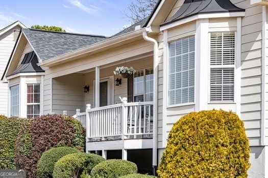 property entrance featuring a porch and a shingled roof