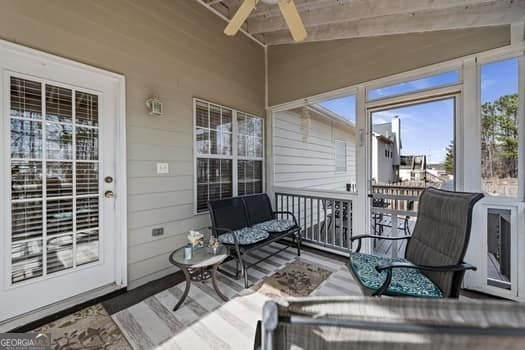 sunroom with lofted ceiling and ceiling fan