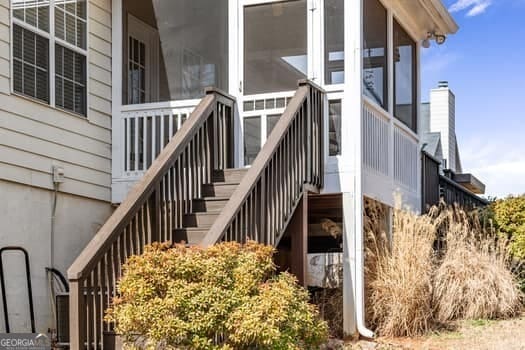 exterior space with a sunroom and stairs