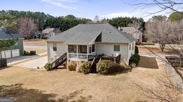 view of front of home featuring stairs, driveway, a porch, and a garage